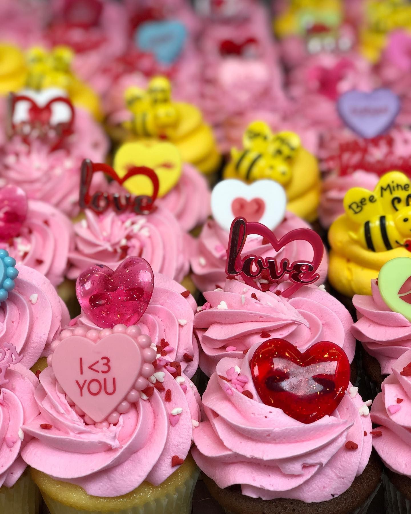 Close-up of pink frosted cupcakes, Valentine's Day themed with heart and