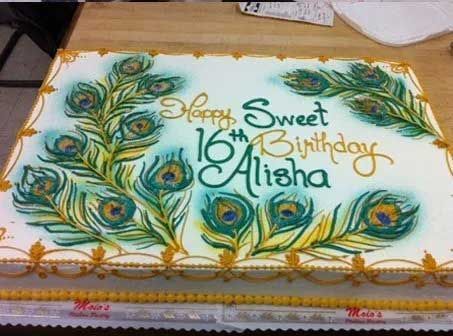 Cake decorated with peacock feathers and
