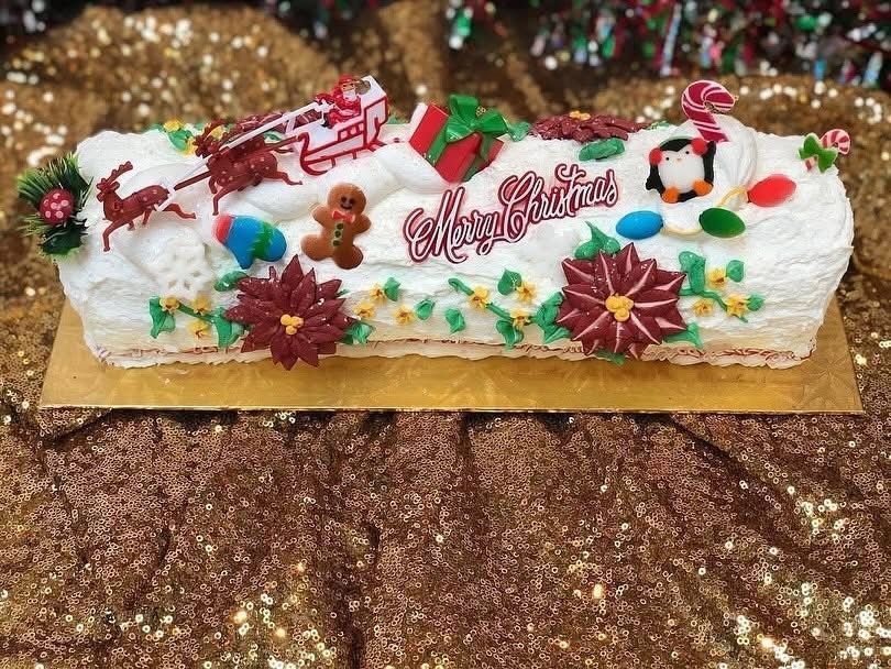 Christmas Yule log cake decorated with Santa's sleigh