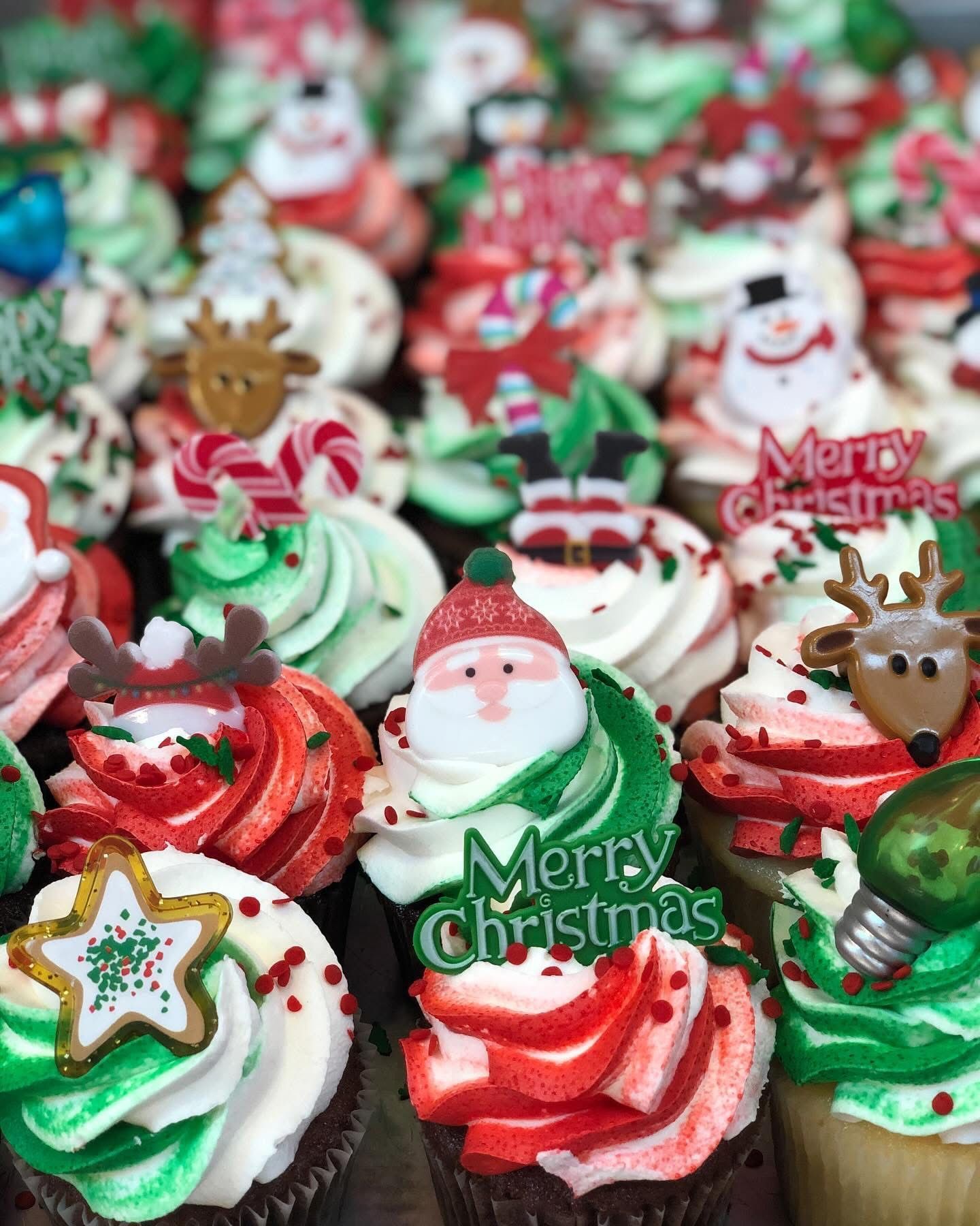 Christmas cupcakes, various decorations with green, red, and white frosting.