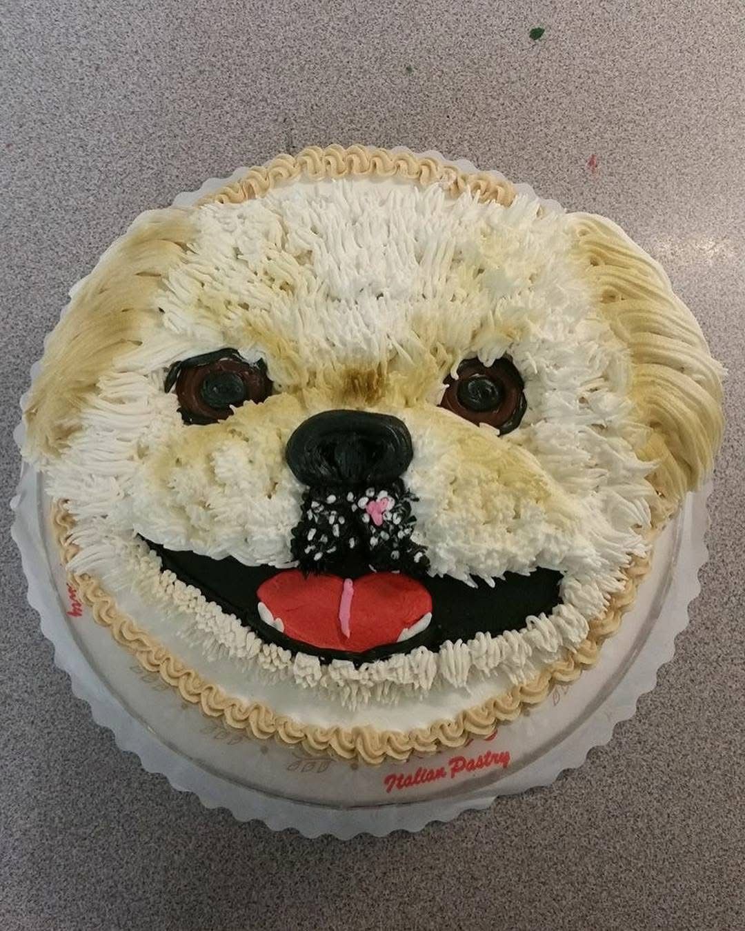 Dog-shaped cake decorated with buttercream frosting.