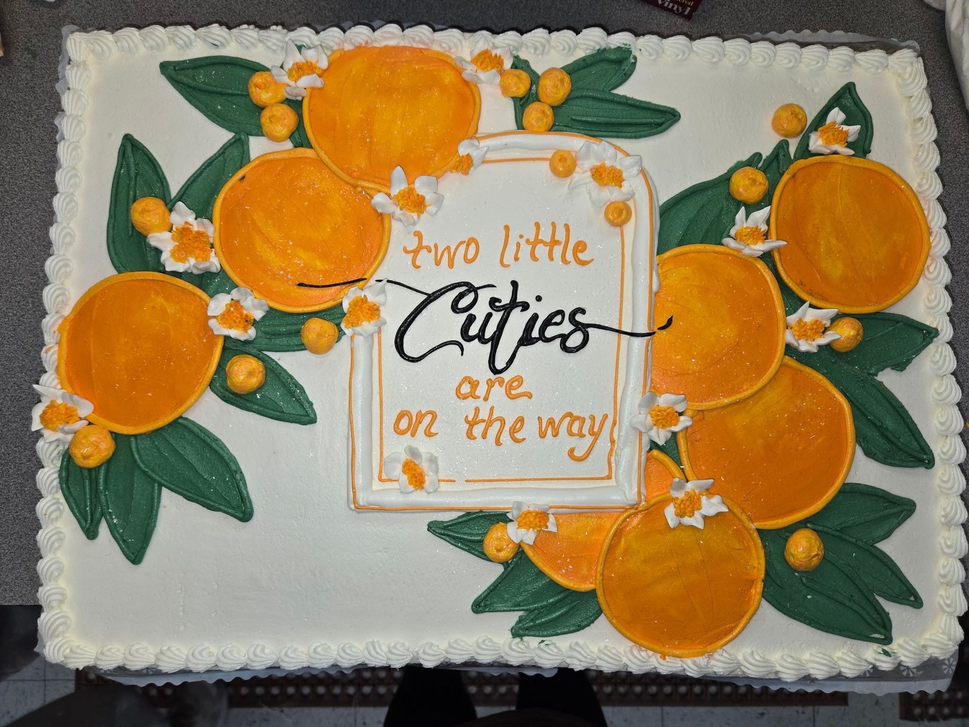 Cake decorated with oranges and leaves.