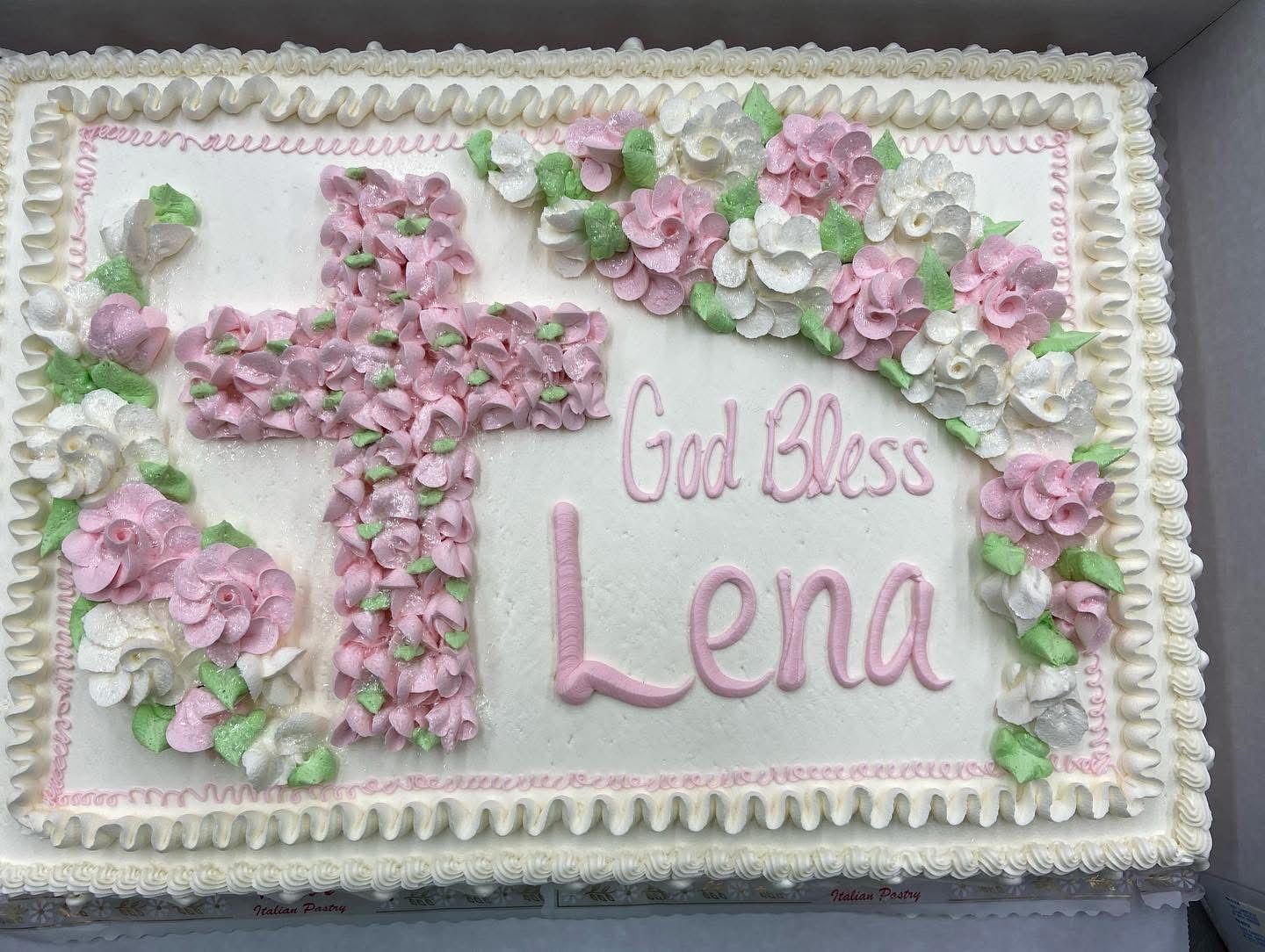 Cake decorated with pink and white flowers.