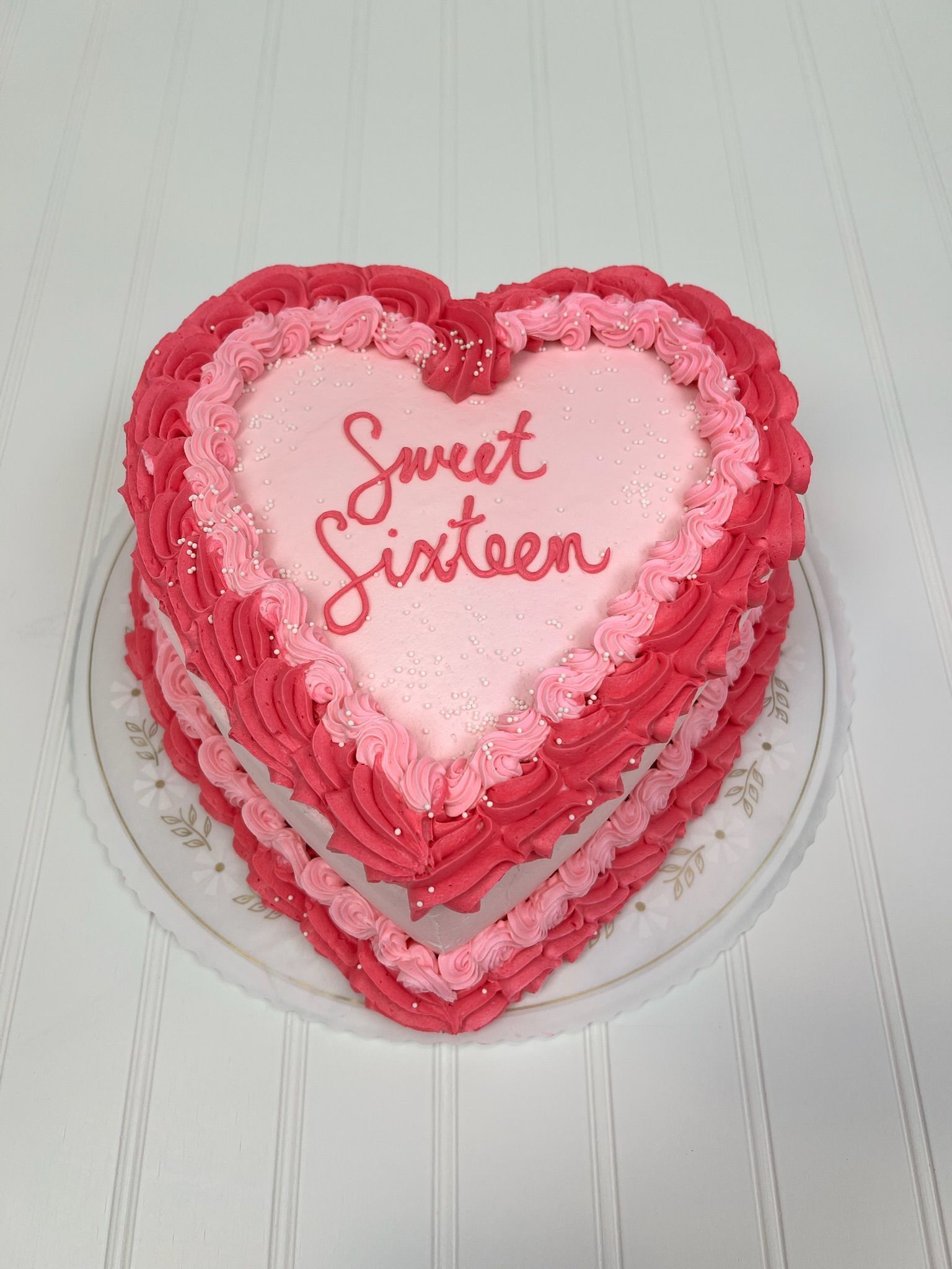 Heart-shaped cake with pink and red frosting