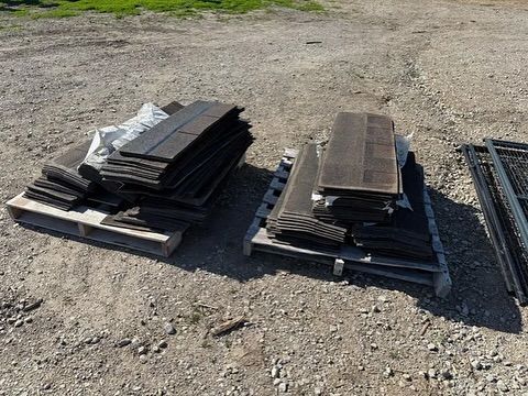A pile of wood is sitting on top of a wooden pallet.
