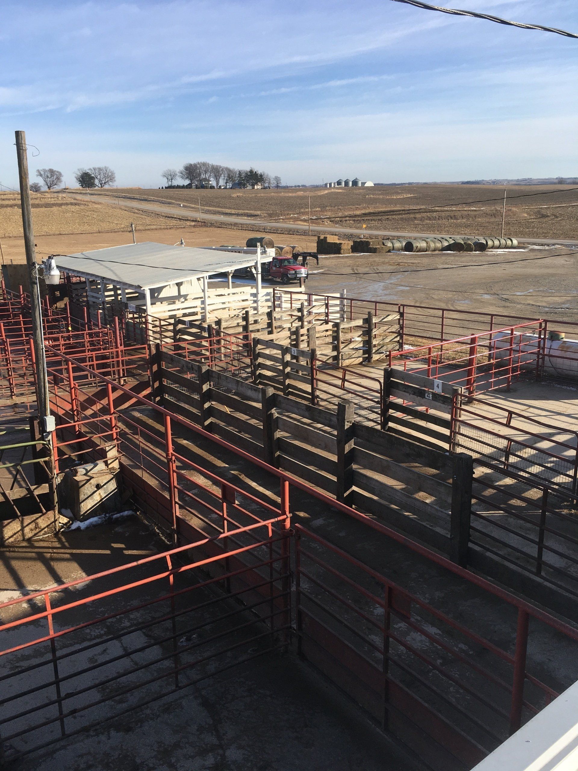 An aerial view of a rodeo arena with a barbed wire fence