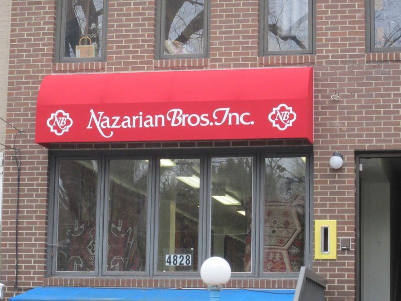 Red awning over a brick building with 