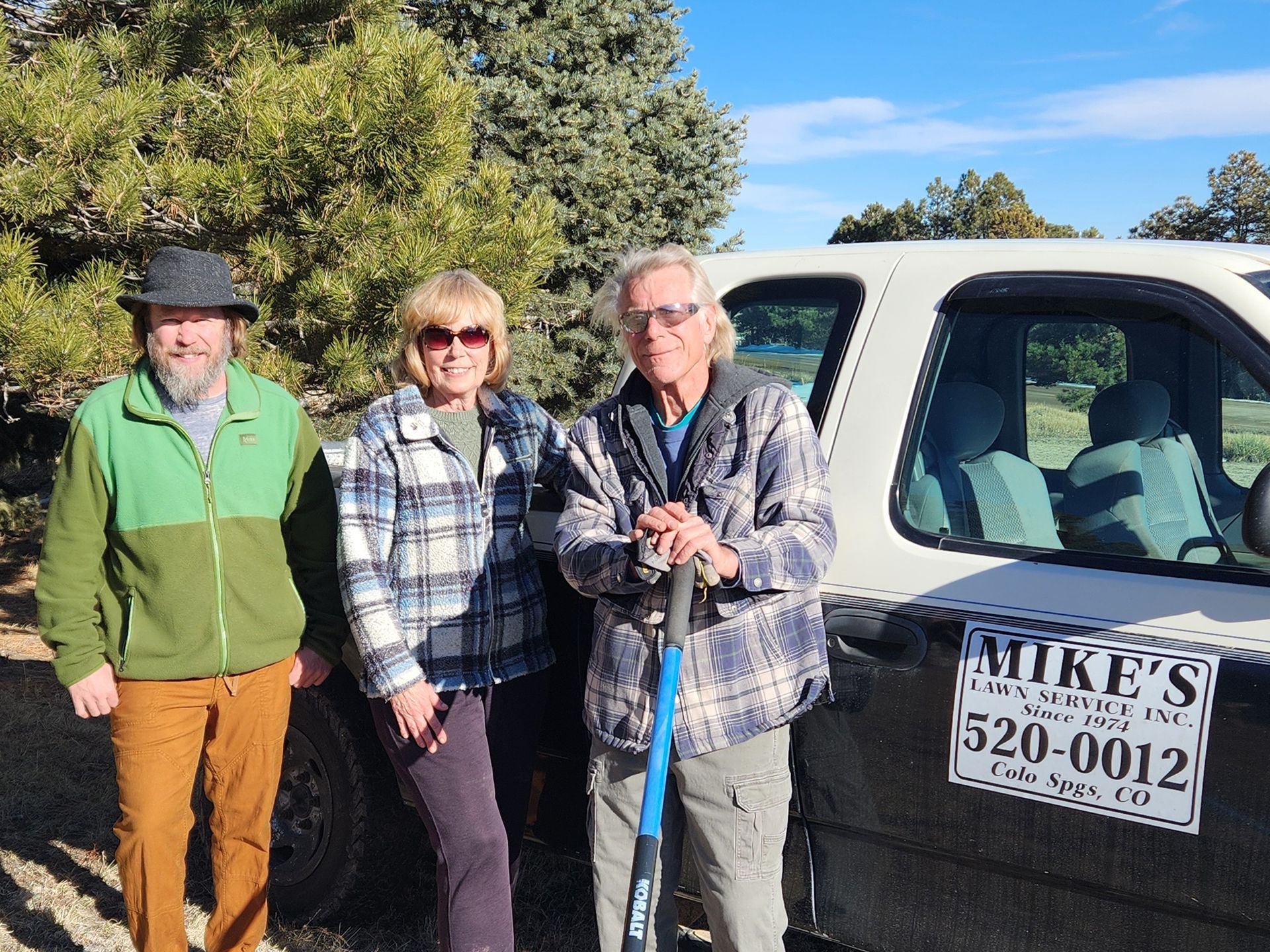 The Mike's Lawn Service team standing in front of their truck.