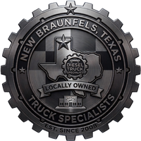 Logo for New Braunfels Truck Specialists, featuring a dark metallic gear emblem and Texas silhouette.