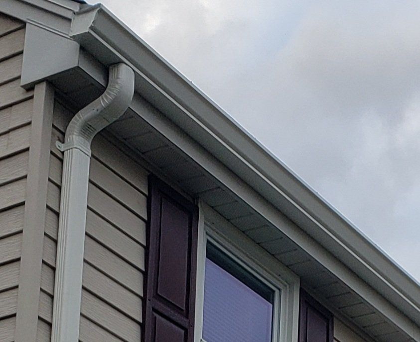 A house with a gutter on the side of it