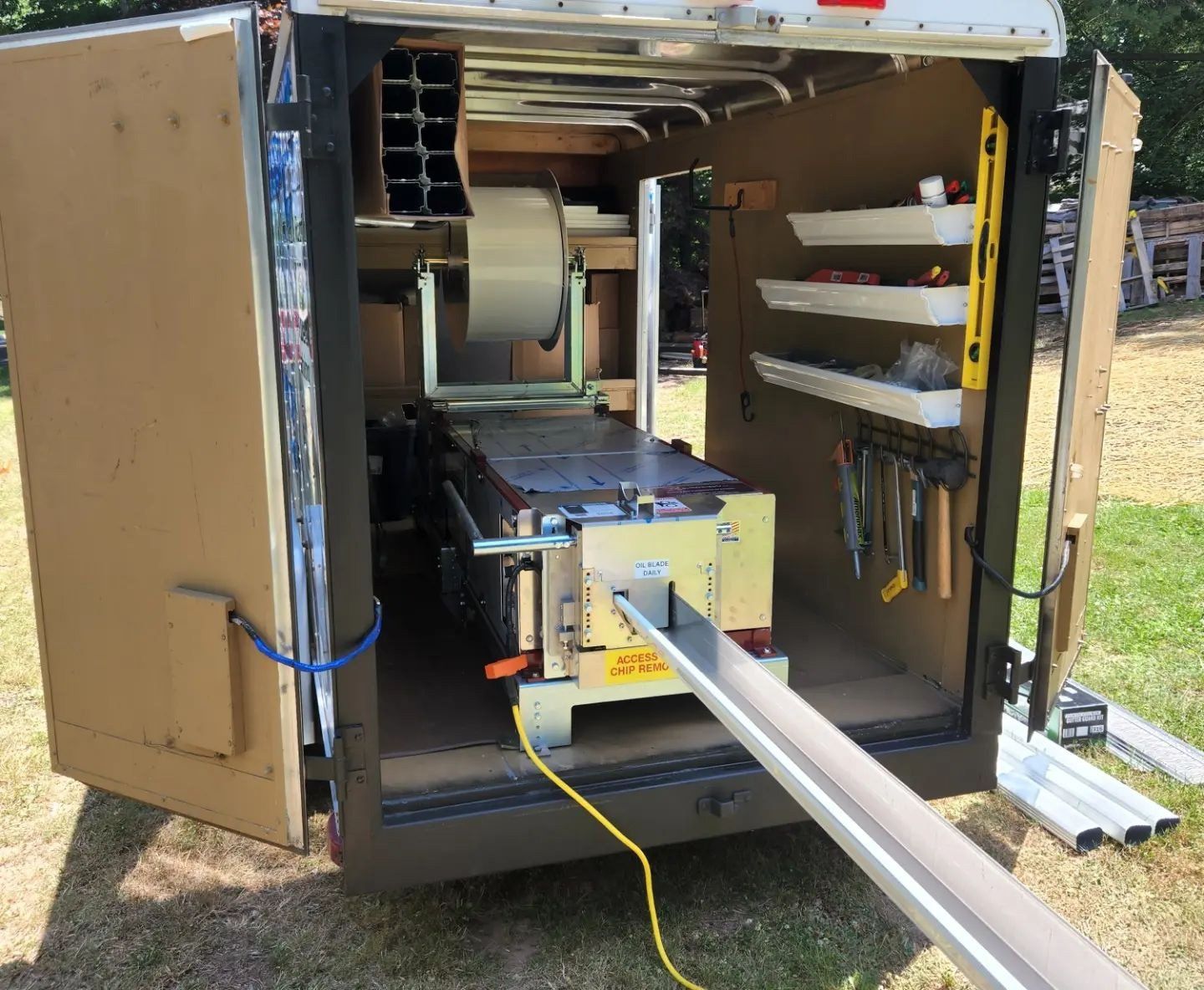 A trailer with a table and tools inside of it