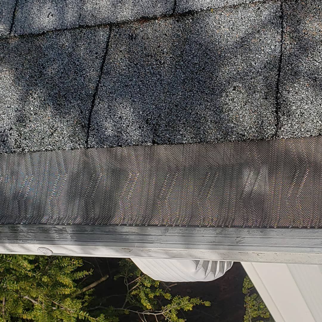 A close up of a roof with a gutter on it.