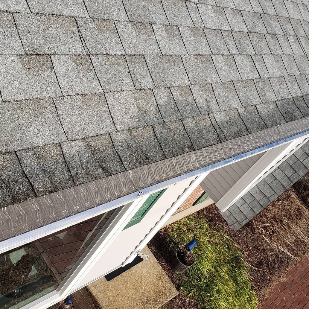 An aerial view of a house with a roof and gutter.