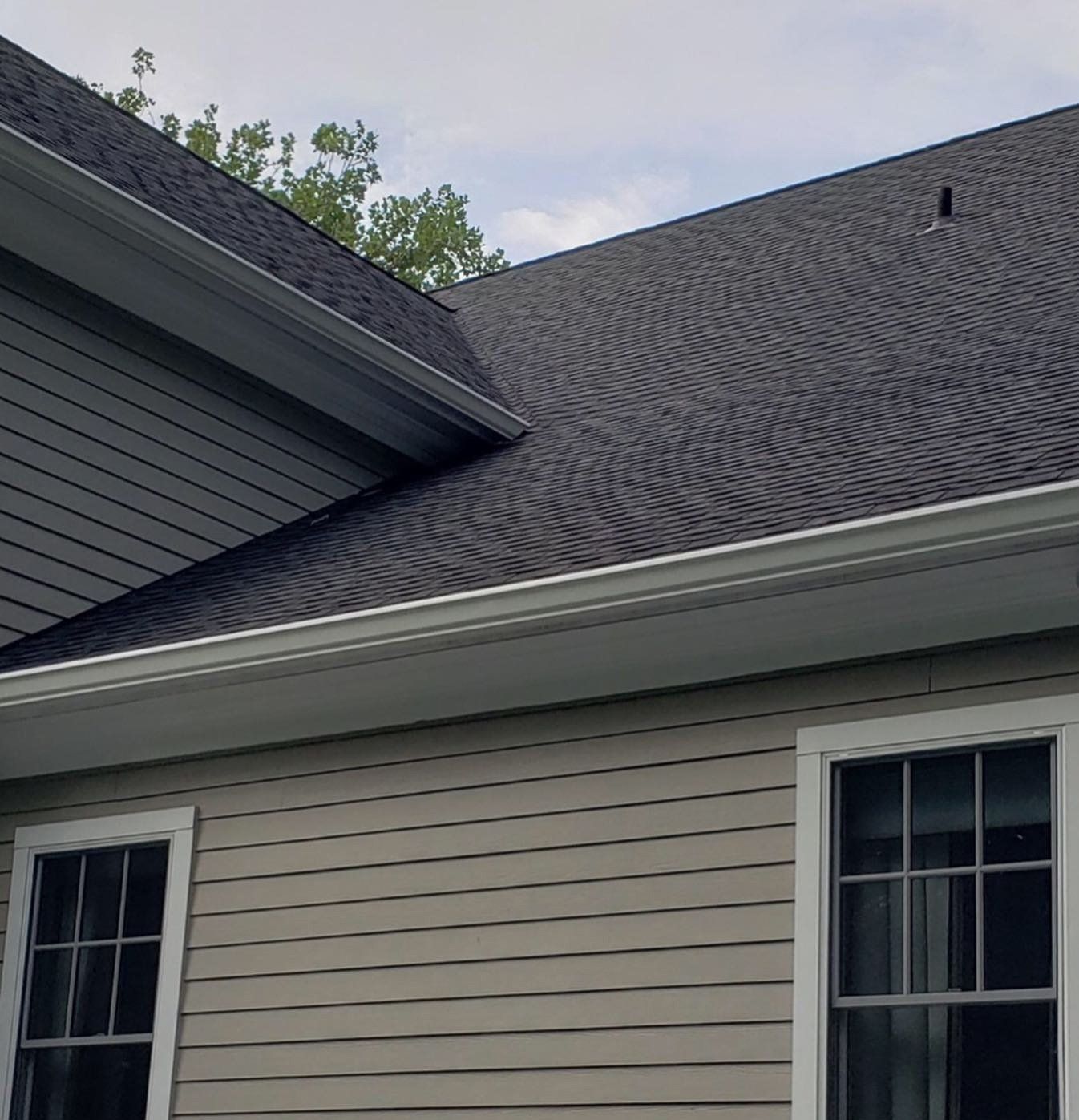 A house with a black roof and white windows