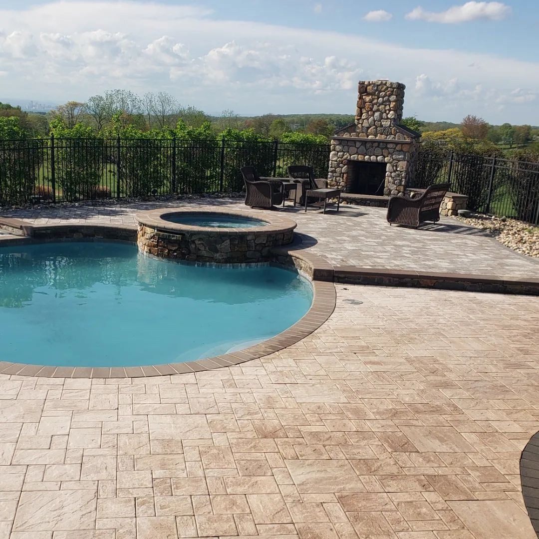 A large swimming pool with a fireplace in the background