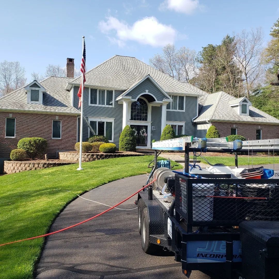 A large house with a trailer parked in front of it.