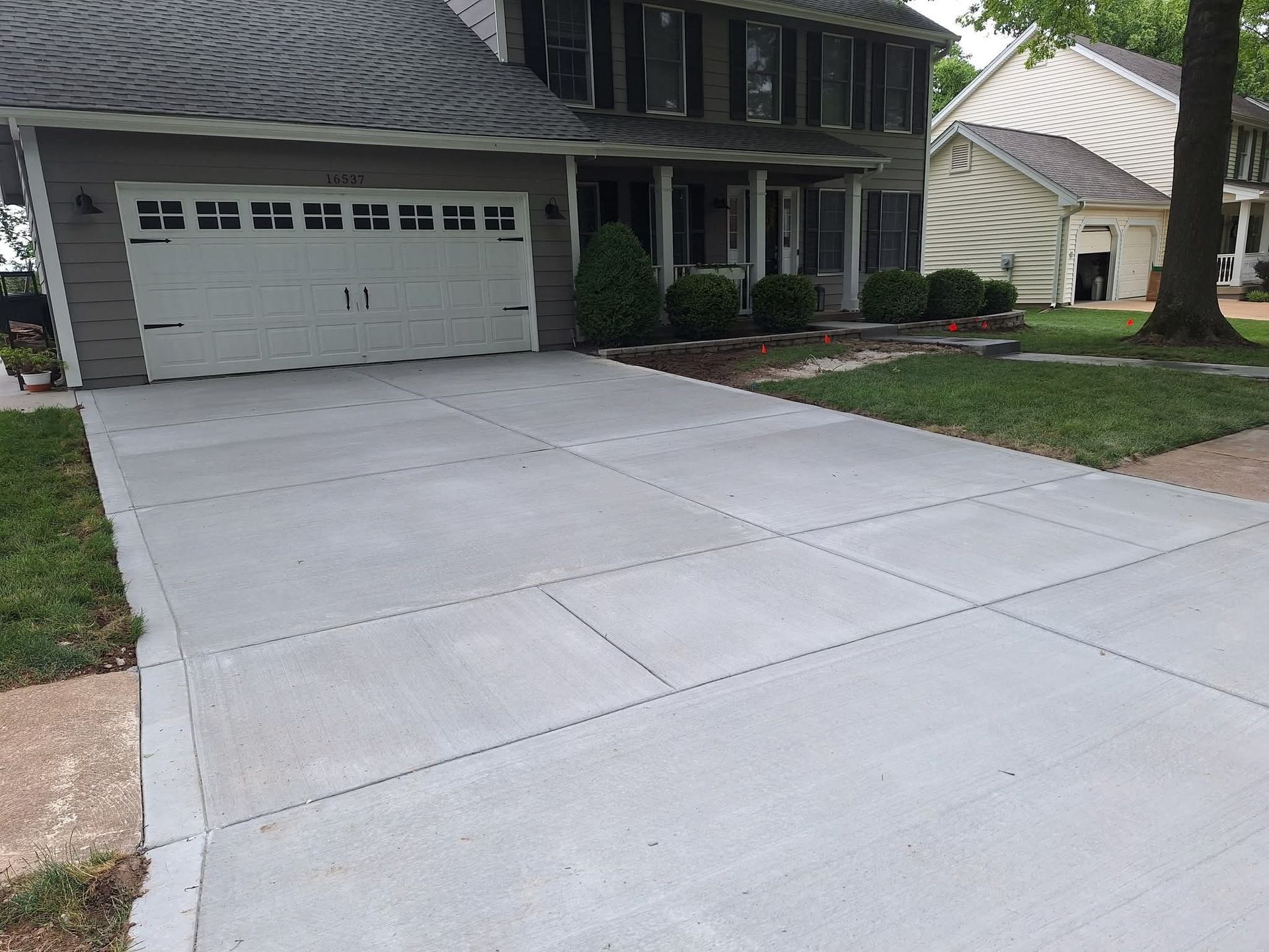 Suburban house with a wide concrete driveway and attached garage