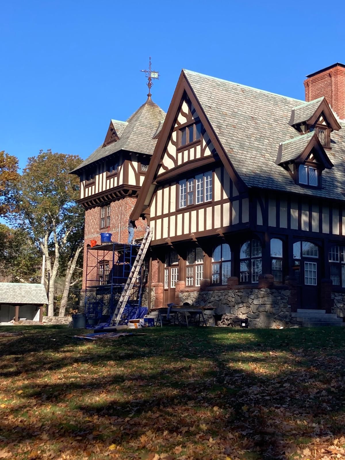 A large house with a ladder in front of it.