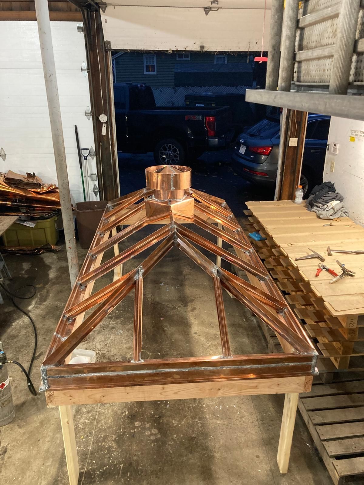 A wooden structure is being built in a garage.
