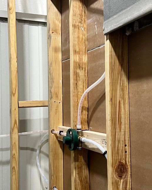 A wooden wall with a hose attached to it.