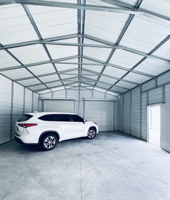 A white suv is parked inside of a garage