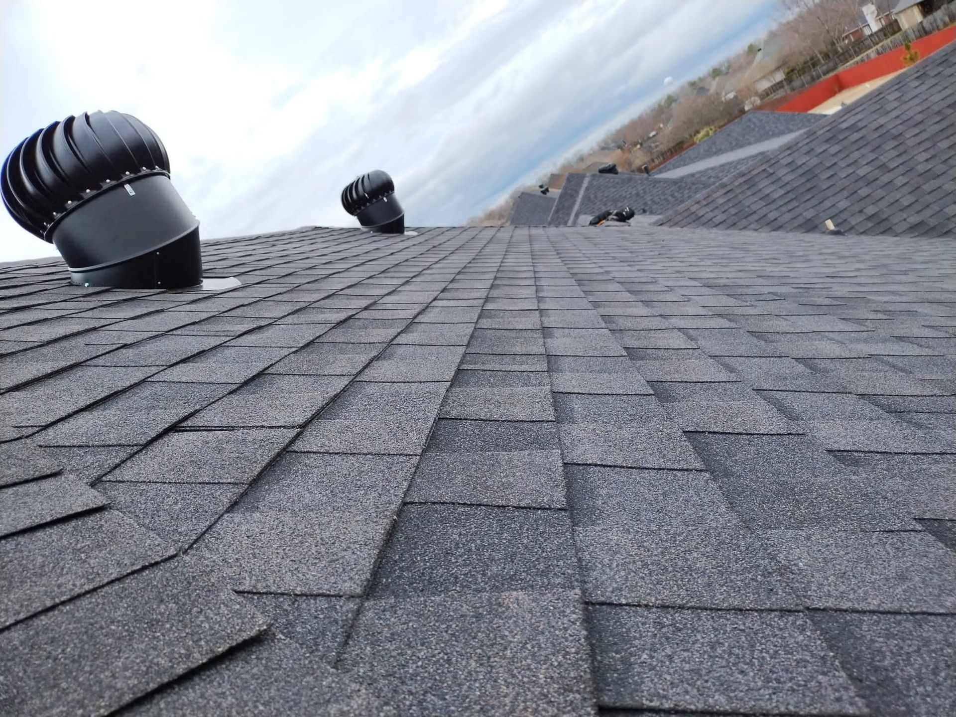 A close up of a roof with a few vents on it