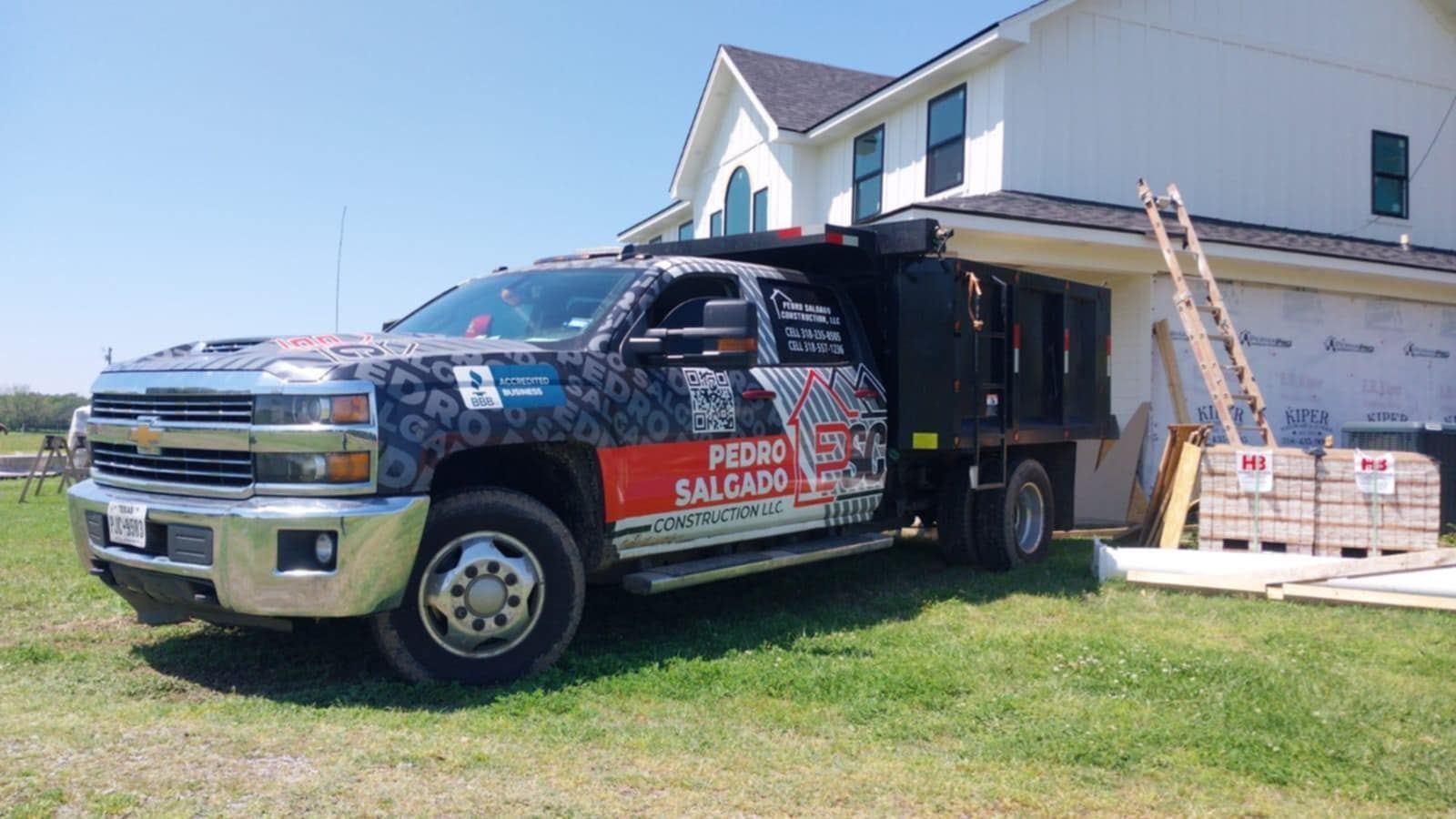 A truck is parked in front of a house under construction.