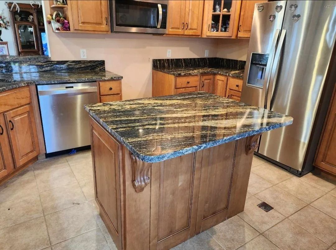 Kitchen with granite countertops, stainless steel appliances, and wooden cabinets.
