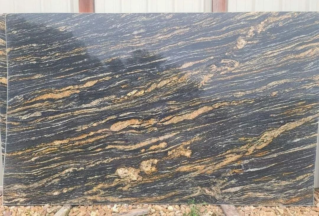 Black granite slab with gold and tan veining.