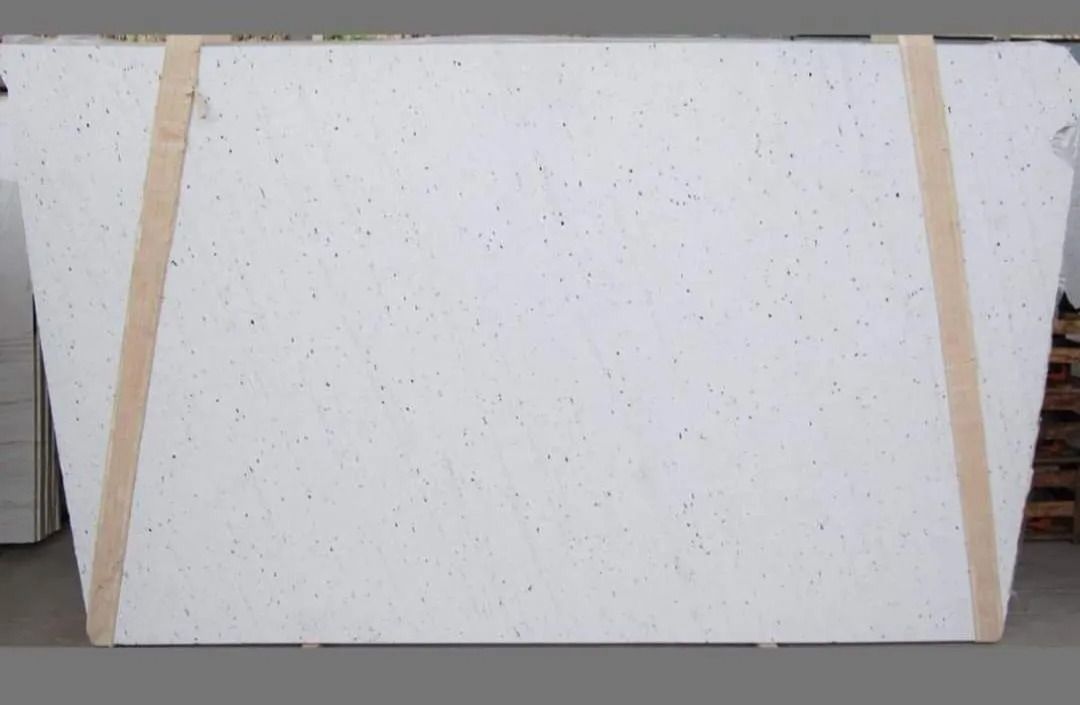 Large white slab secured with beige straps.