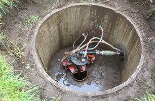 A hole in the ground with a machine in it.