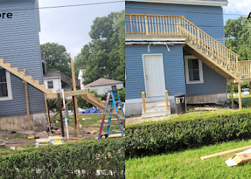 Blue building with yellow staircase and a playground slide in a grassy yard, viewed from across the street