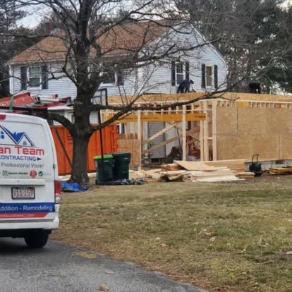 House under construction with wooden framing and a contractor van parked in the foreground