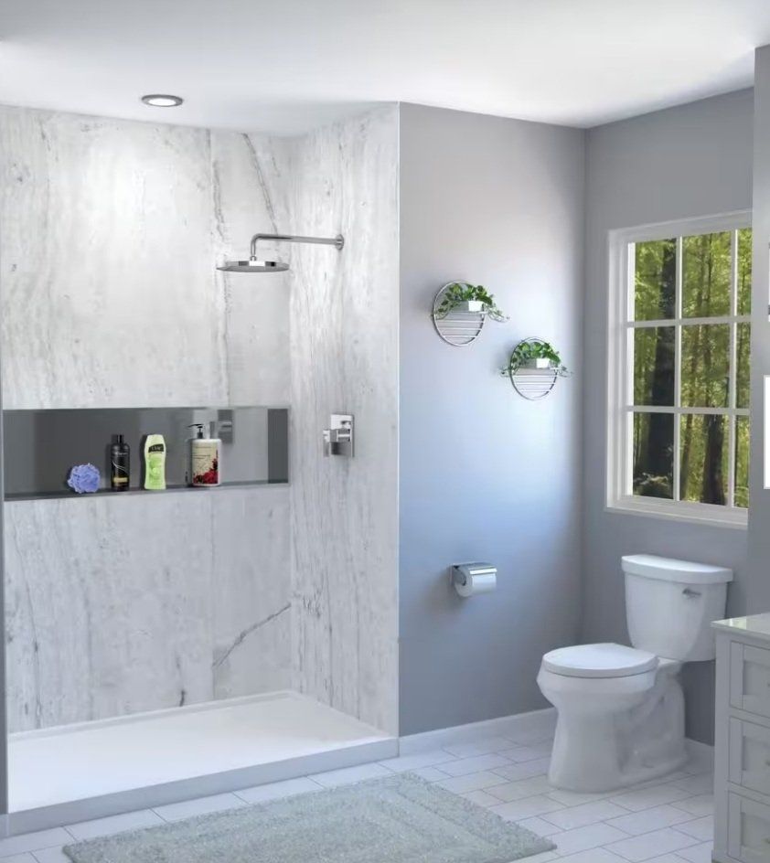 Modern bathroom with marble shower, gray walls, white toilet, and window with plants