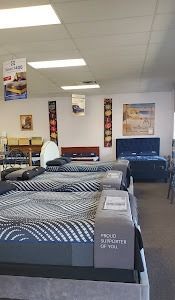 A mattress store filled with lots of beds and mattresses.