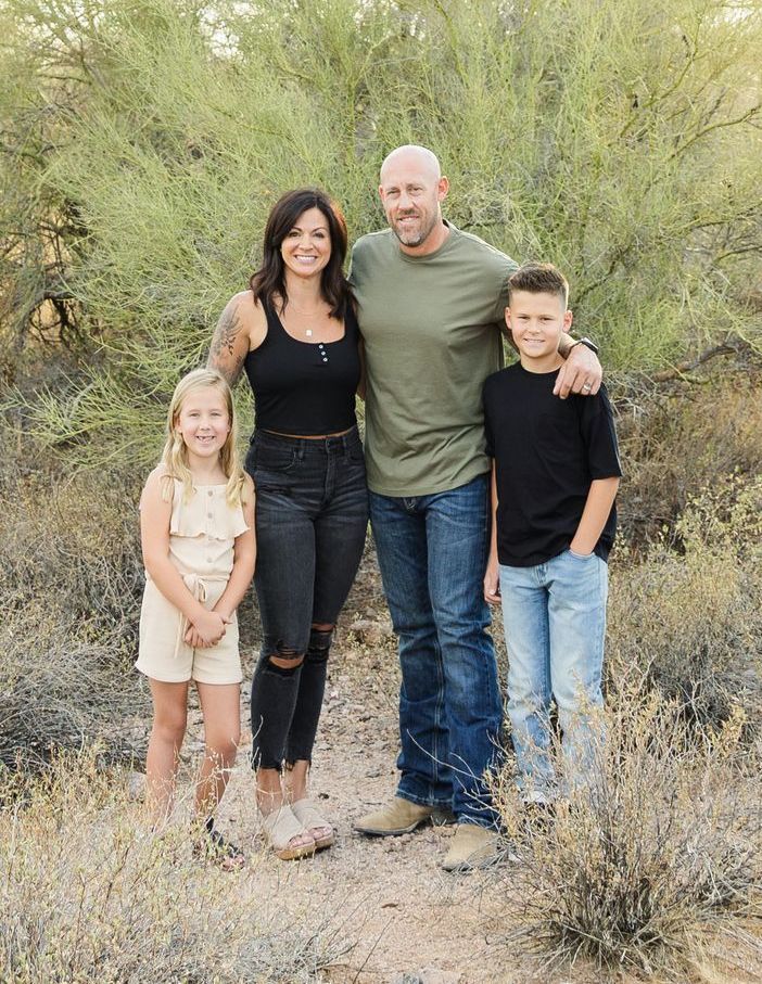 A family is posing for a picture in the desert.