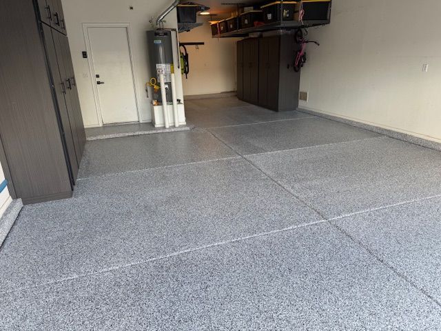 A garage with a gray floor and white walls.