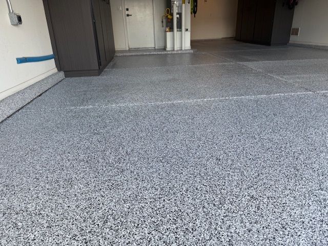 A close up of a gray concrete floor in a garage.
