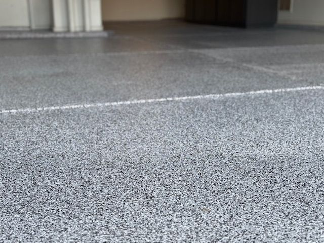 A close up of a gray concrete floor in a garage.