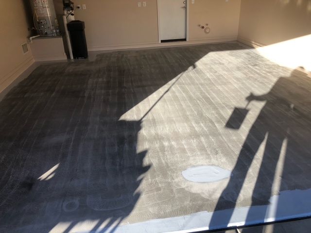 A shadow of a person is cast on the floor of a room