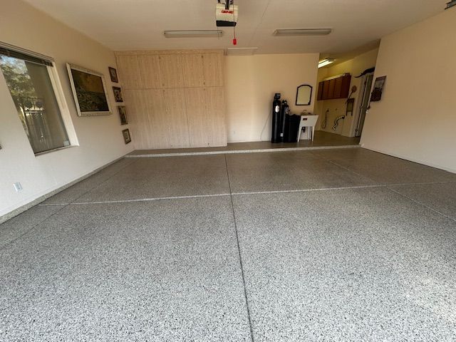 A garage with a gray floor and white walls