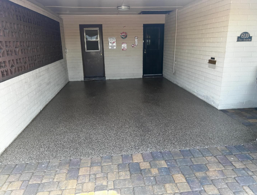 A garage with a brick floor and a door