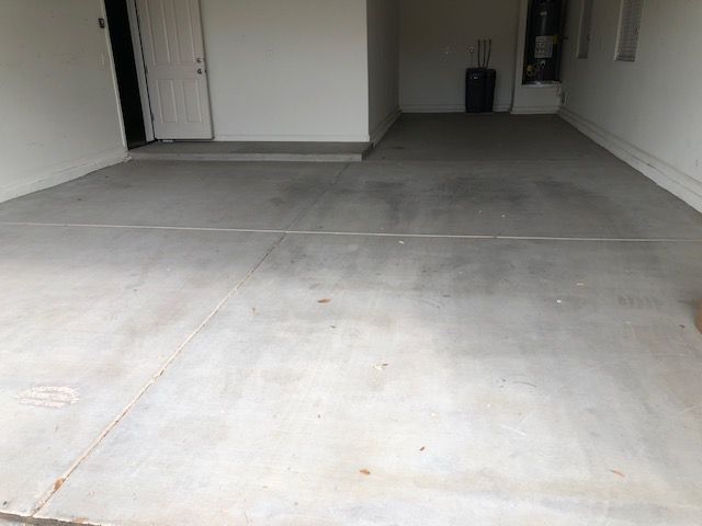 A concrete floor in a garage next to a door.