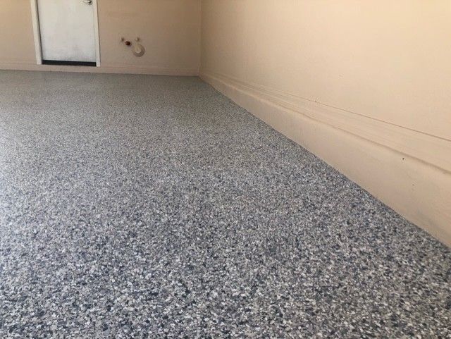 A garage with a concrete floor and a door.