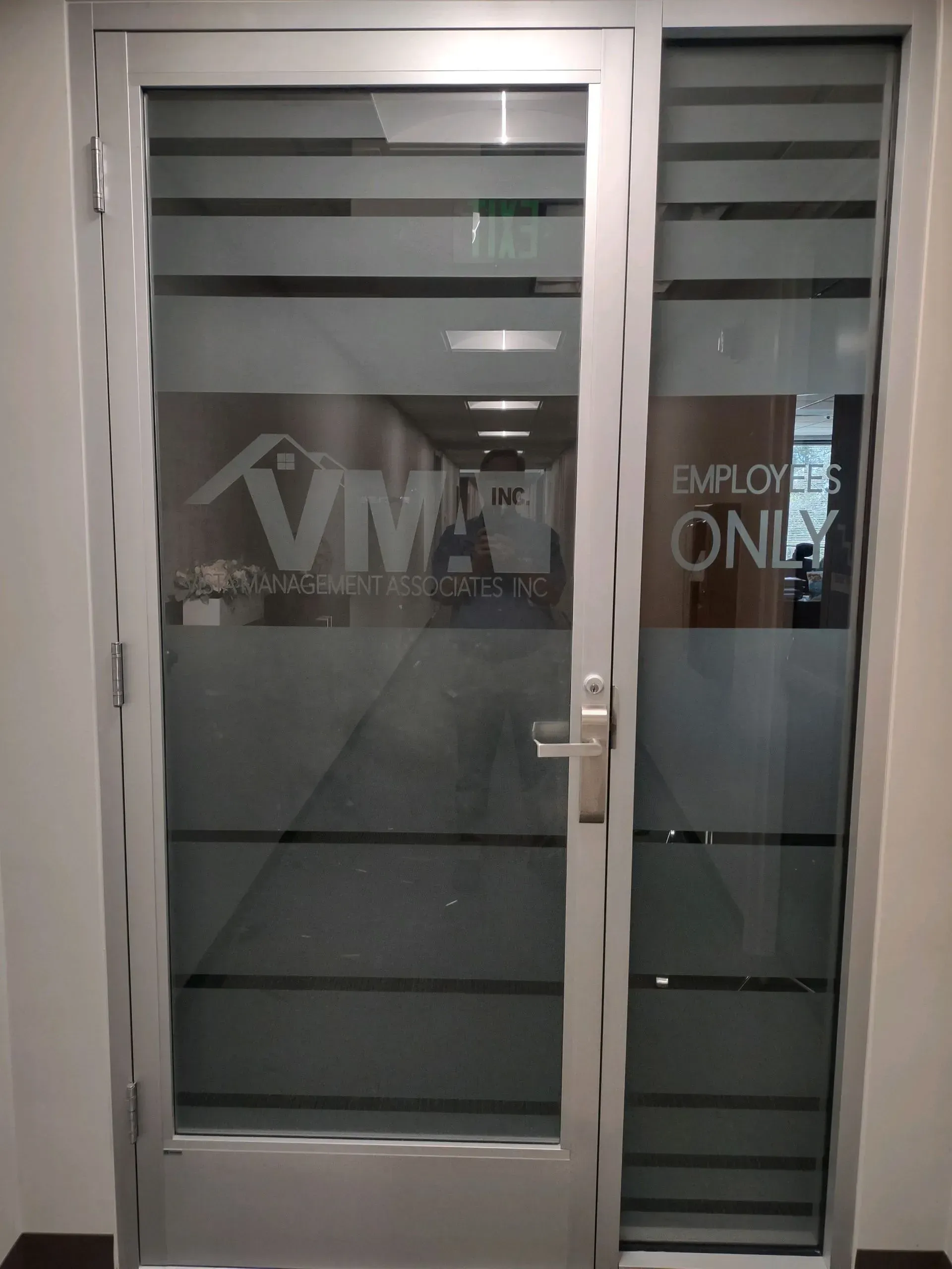 Silver framed glass door with horizontal frosted stripes. 