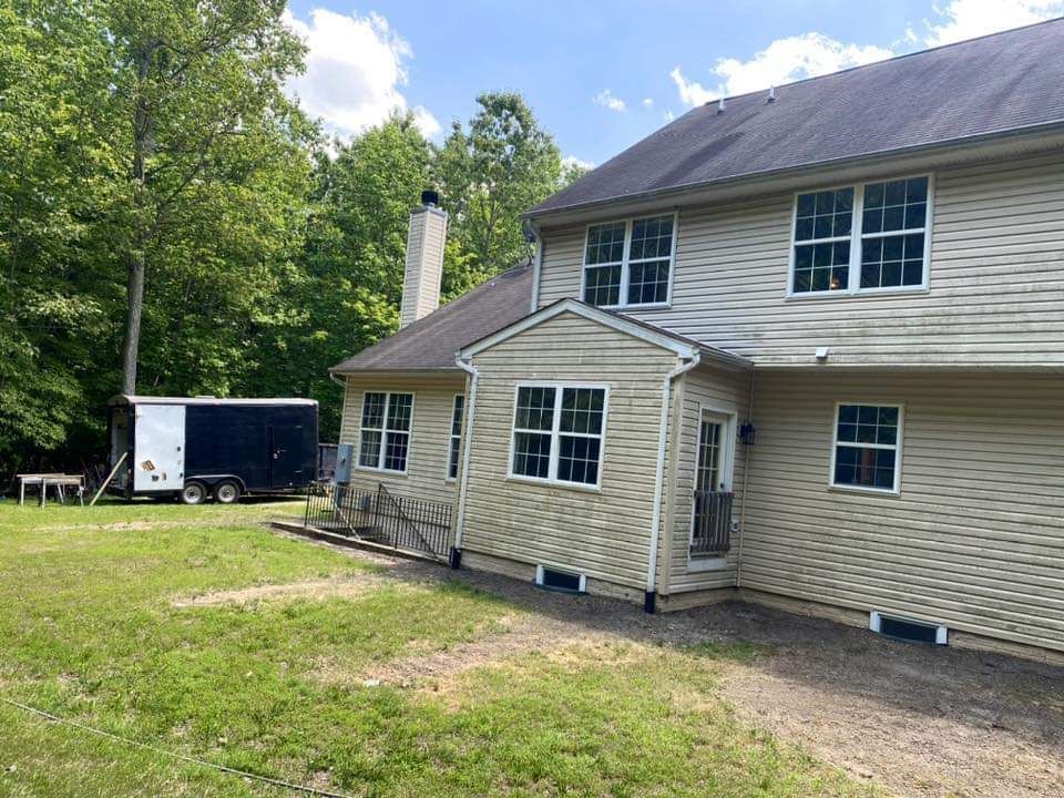 a large house with a trailer parked in front of it