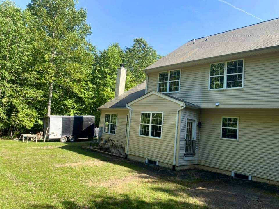 a large house with a trailer parked in front of it