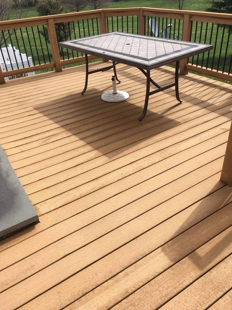 a wooden deck with a table and chairs on it