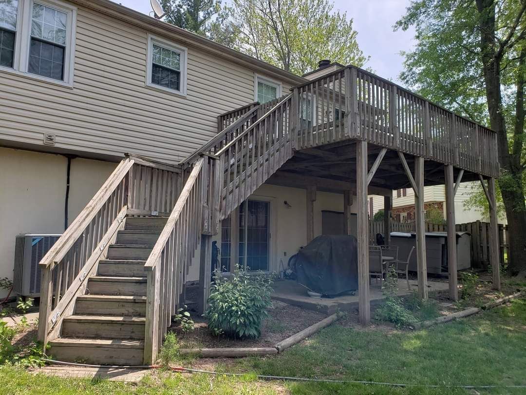 a house with a large deck and stairs leading up to it