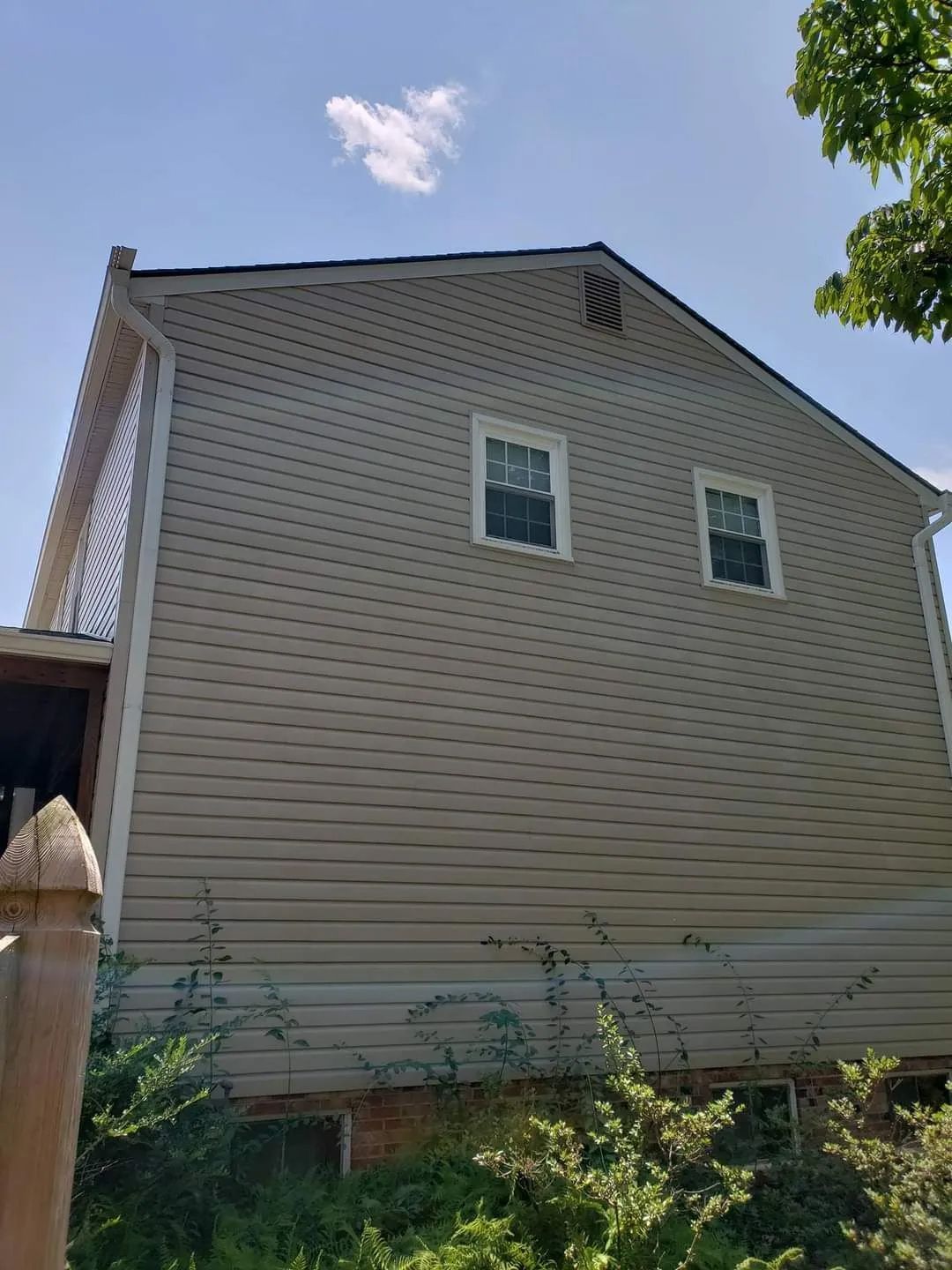 a house with a lot of windows and a blue sky in the background